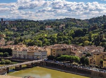 The Arno River and the San Miniato al Monte Church in Florence in Italy